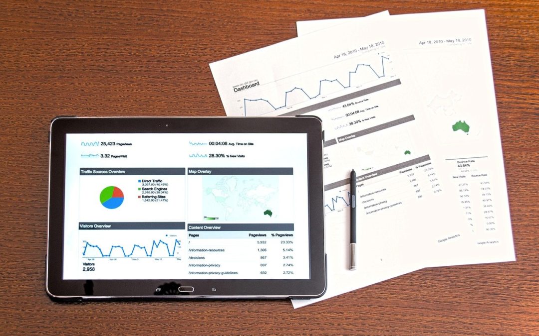 tablet and documents with statistics and financial data