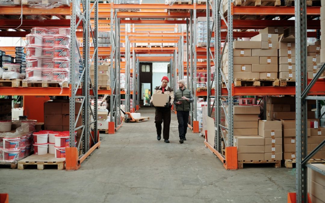 two people inside a warehouse managing inventory
